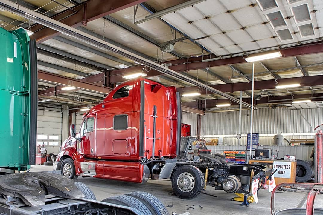 A repair shop with grease pit and equipment for fixing semi-sized and large over-the-road trucks.